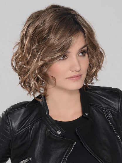 A trendy, mid length lace front wig with perfectly placed layers. The monofilament part placement offers the perfect amount of volume