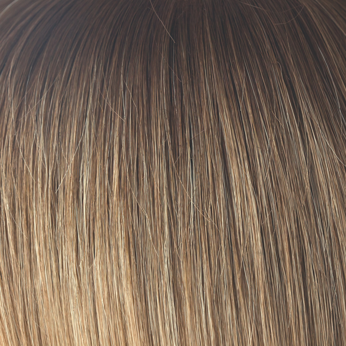 Macadamia-LR  -  The warm rich ombre of the macadamia brown roots blend through into soft, golden blond and walnut cream slices. With a luxury, velvet finish, Macadamia-LR looks great in long and mid length styles.